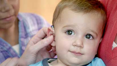 Young child with hearing aid