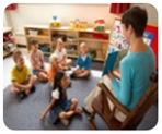 Children watching teacher read book