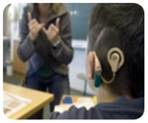 Child with cochlear implant watching sign language