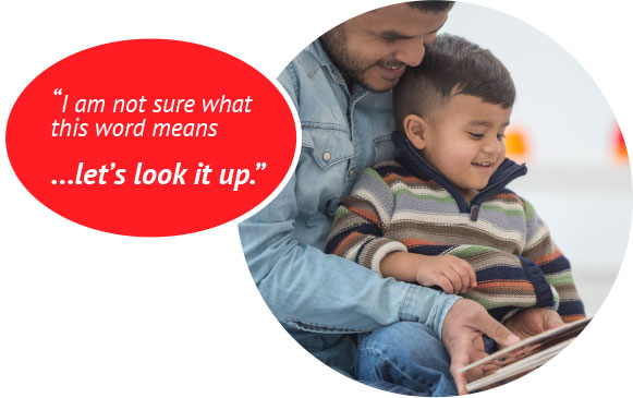 Man reading to child sitting in his lap