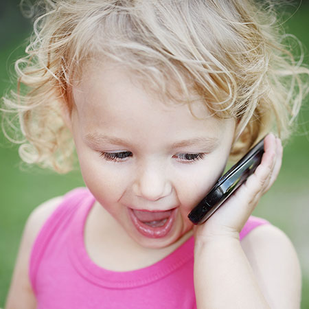 Toddler girl pretending to talk on the phone